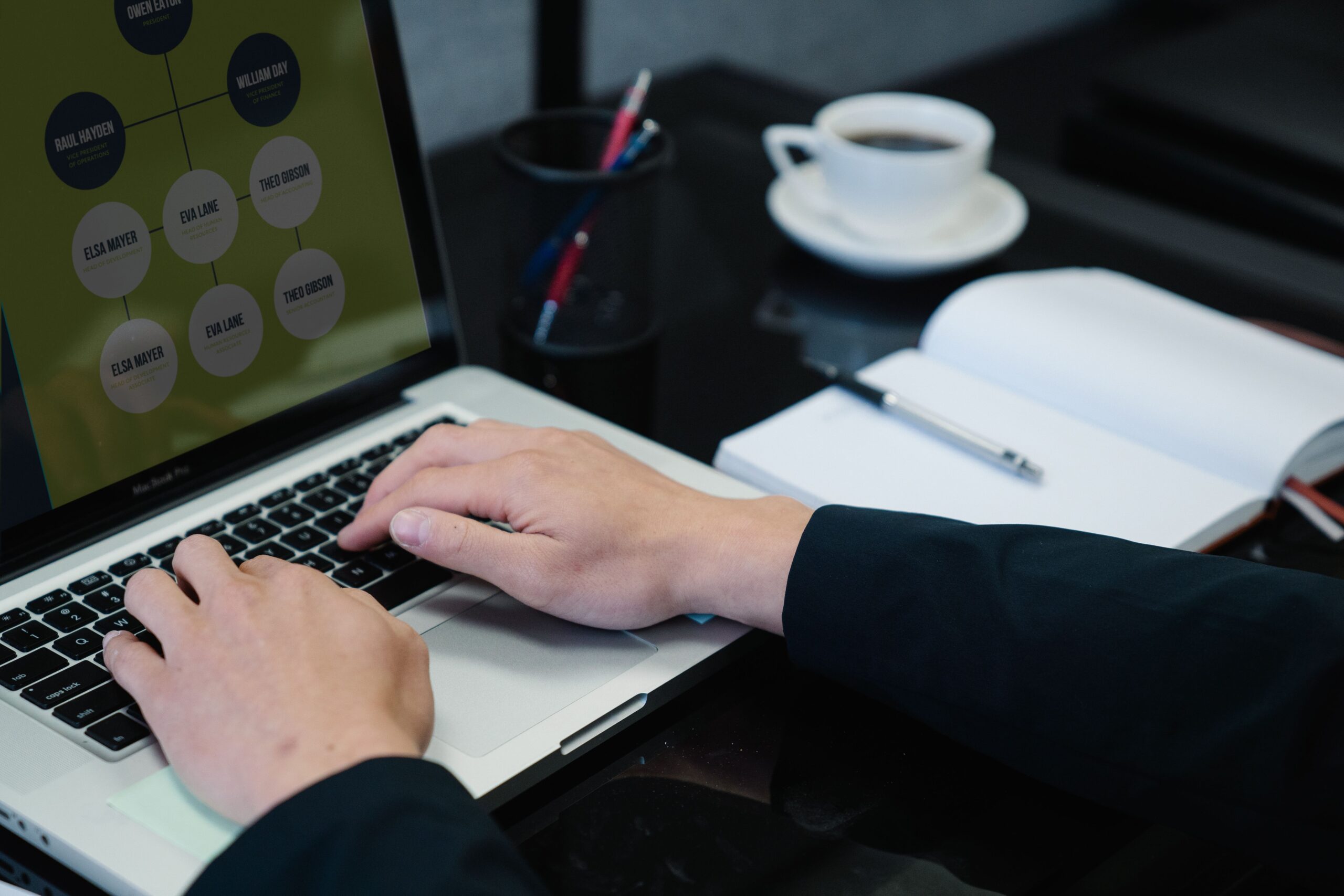 Person typing on a laptop, representing the process of writing and refining AI prompts for content creation