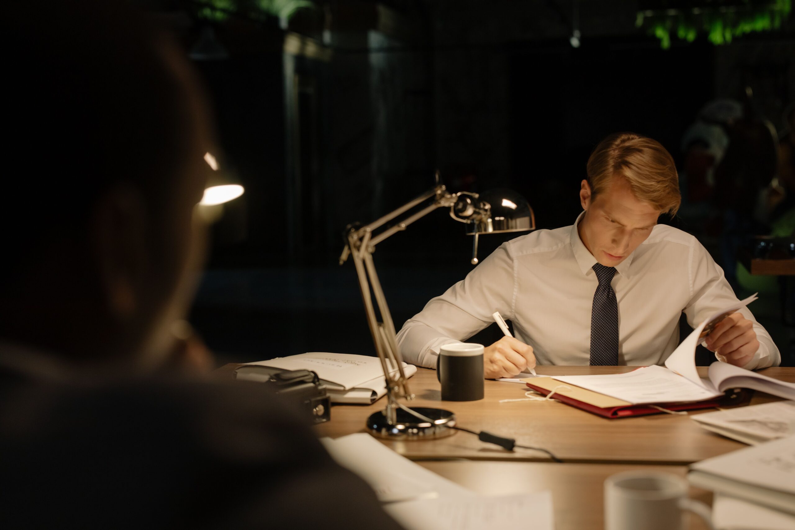 A person closely reading documents at a desk, representing reviewing CPA offer compliance rules