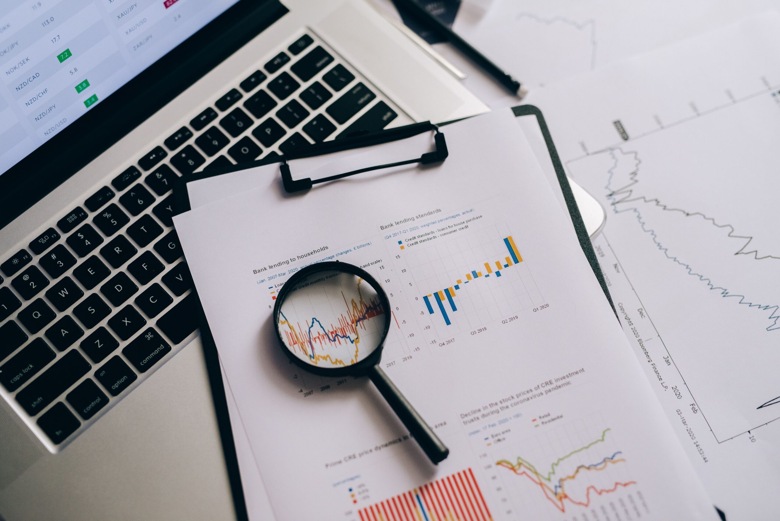 A magnifying glass over financial charts, representing evaluating and comparing CPA networks