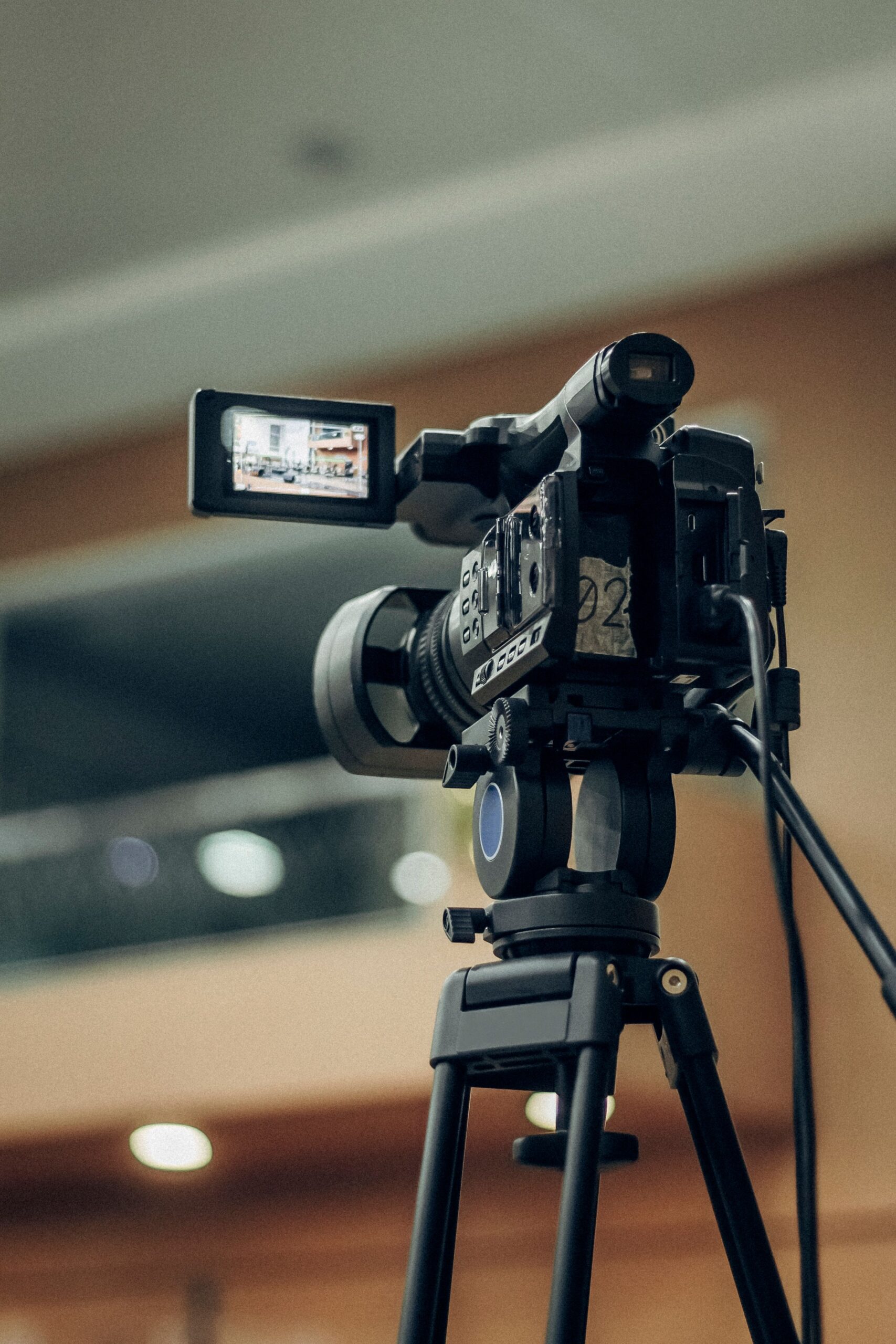 Video camera on a tripod set up for filming, representing YouTube content creation and ad revenue