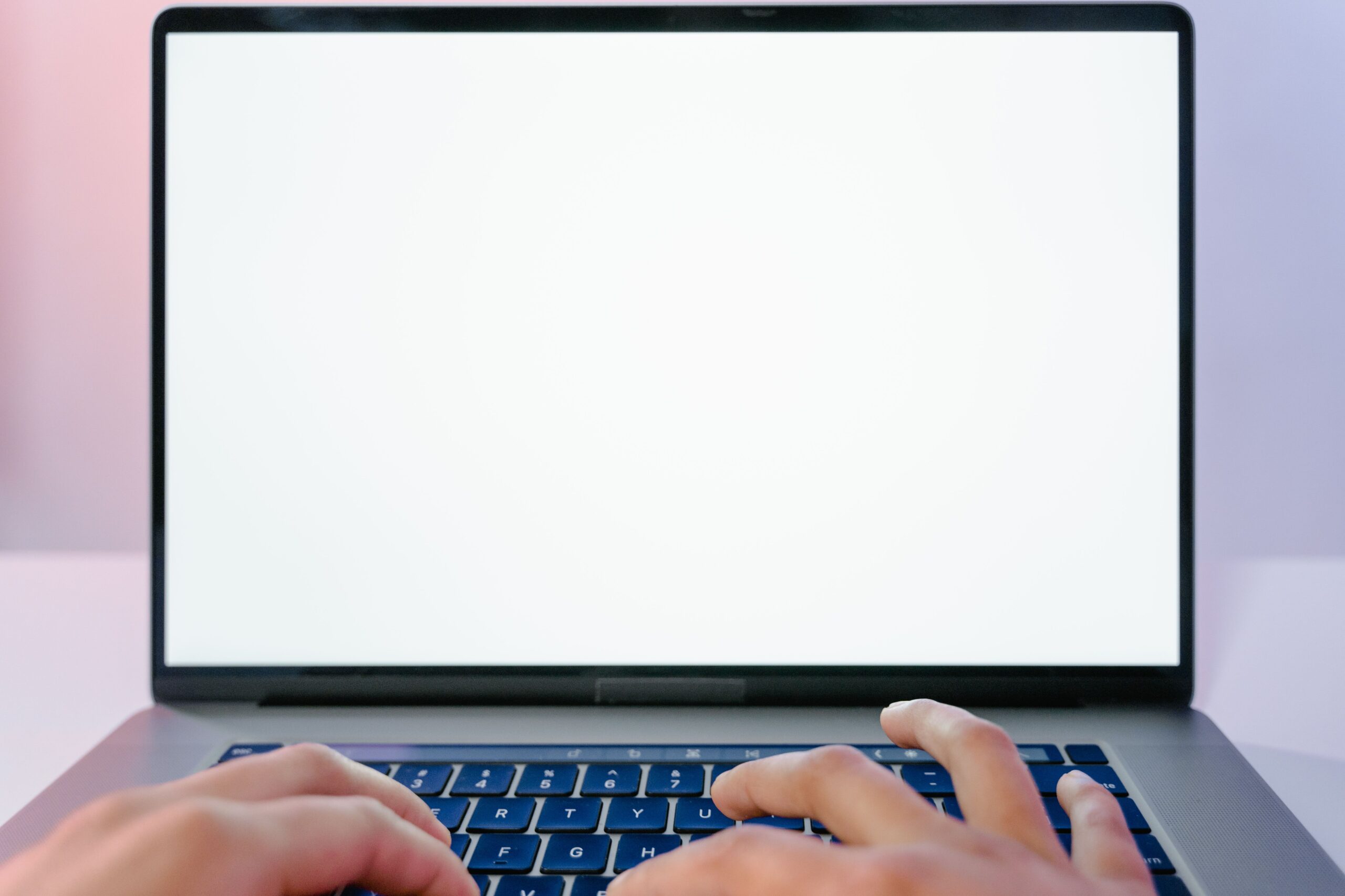 Illustrative close-up of hands typing on a laptop, representing engaging with a paid online trading course