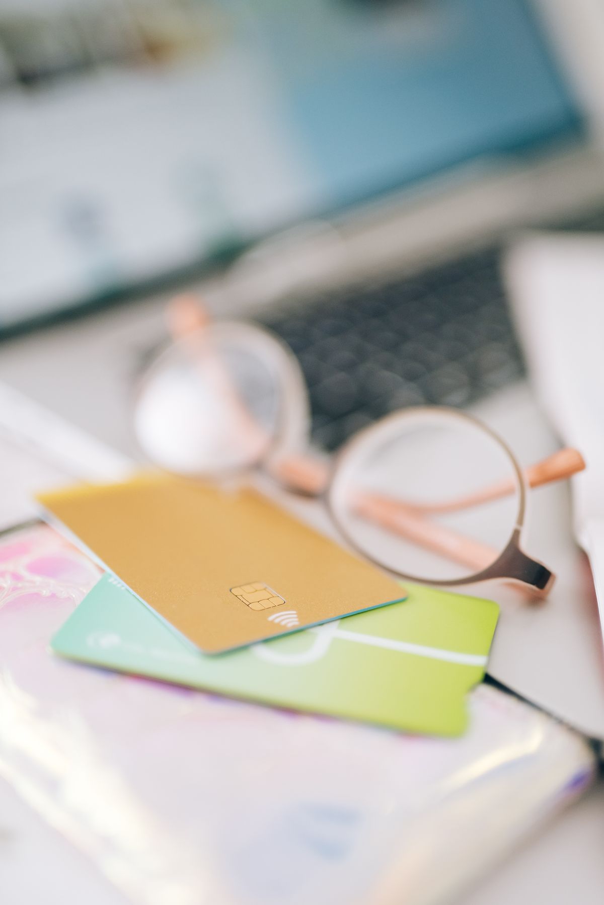 Close-up of blurred credit cards next to eyeglasses, representing fake payment gateway checkout scams