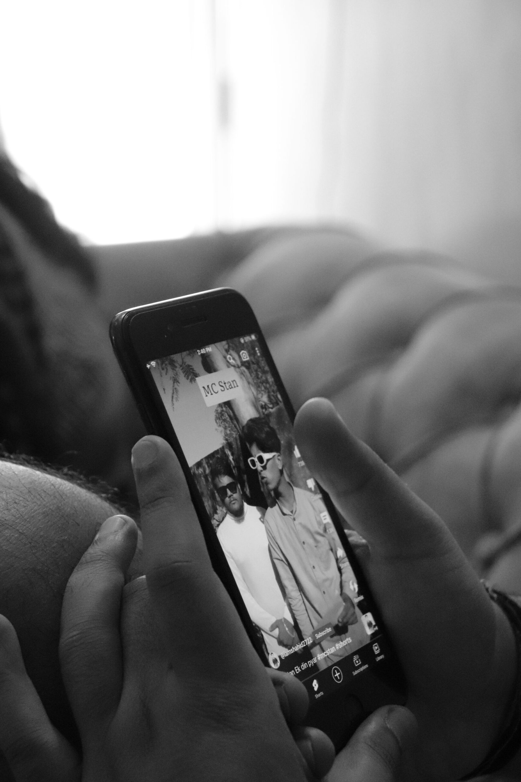 Illustrative close-up of a hand holding a smartphone with content playing on screen, representing a get-paid-to-watch-ads app