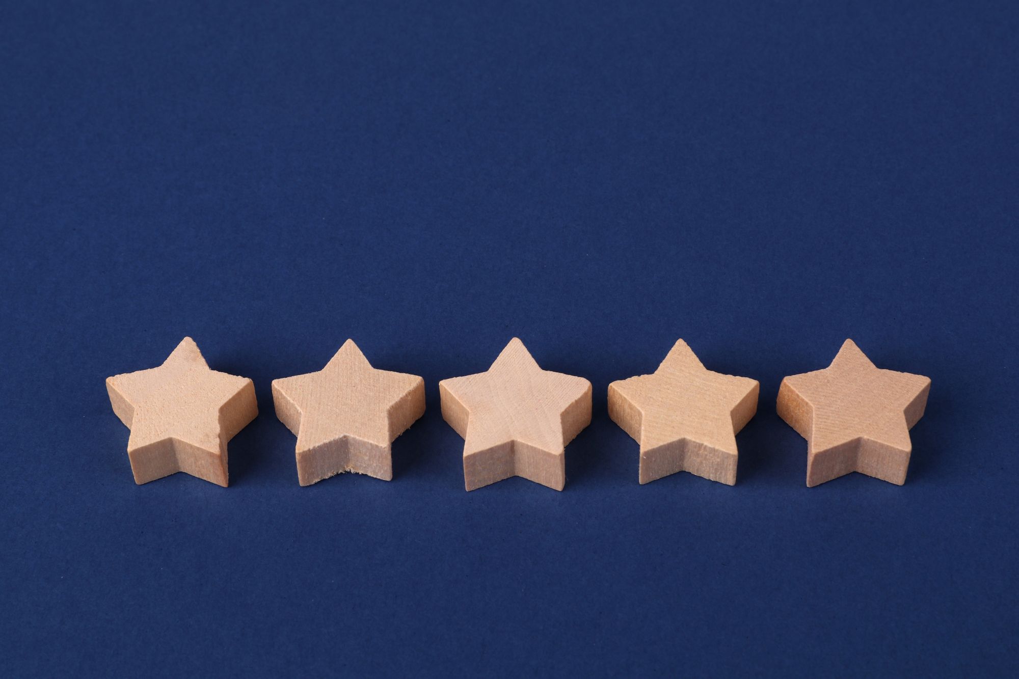 Illustrative photo of five stars arranged in a row, representing a like-rate-review task in a task-based earning app scam