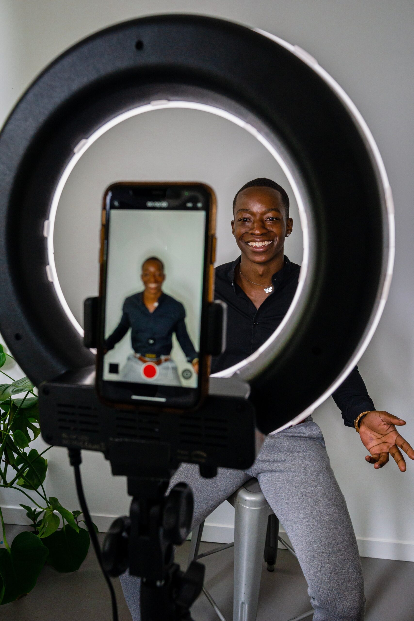 Illustrative photo of a person recording a video testimonial with a ring light, representing fabricated course testimonials