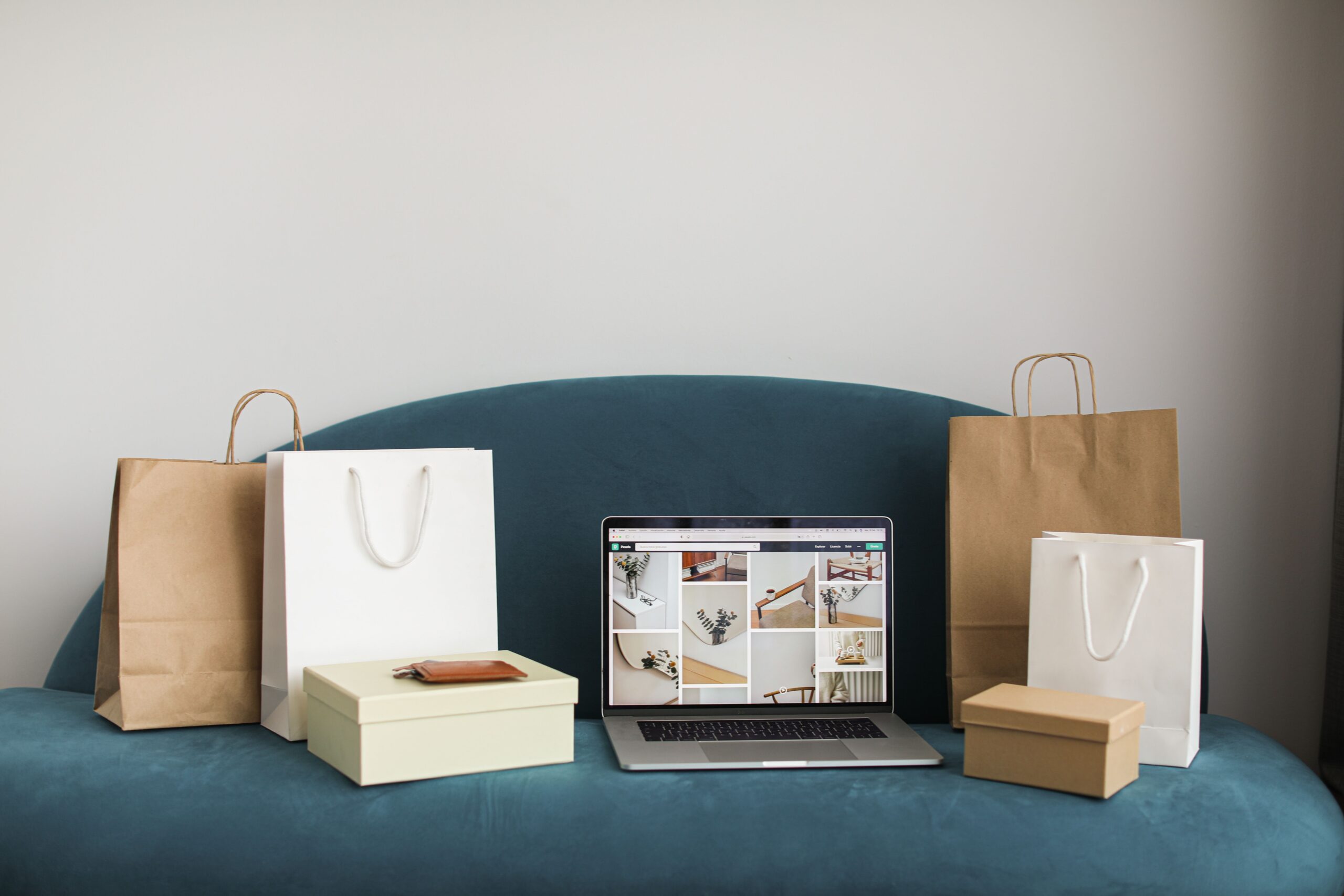 Illustrative photo of a laptop with shopping boxes, representing a done-for-you e-commerce business setup