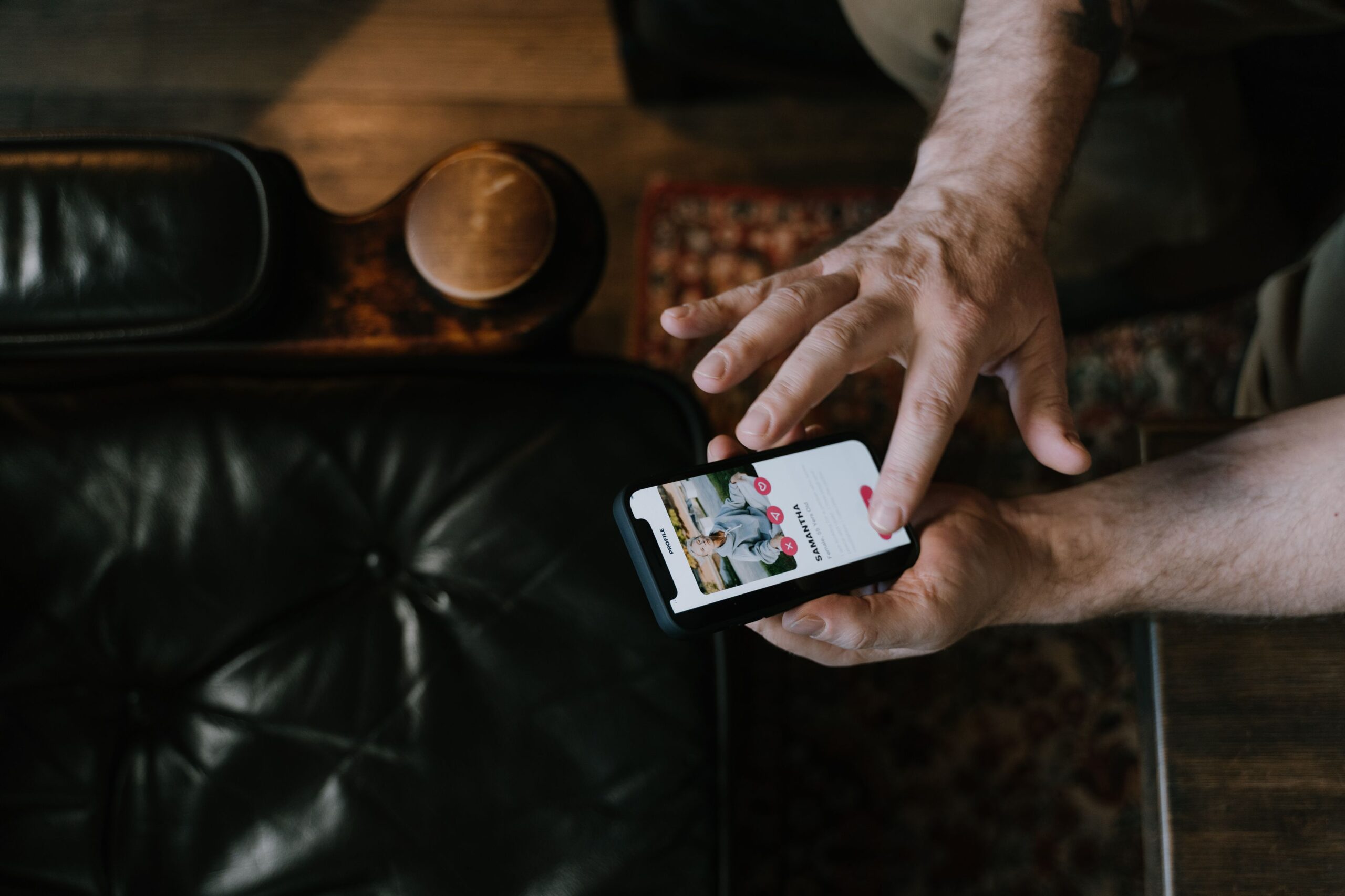 Illustrative photo of someone checking a message on a phone, representing the online-contact stage of a pig butchering scam